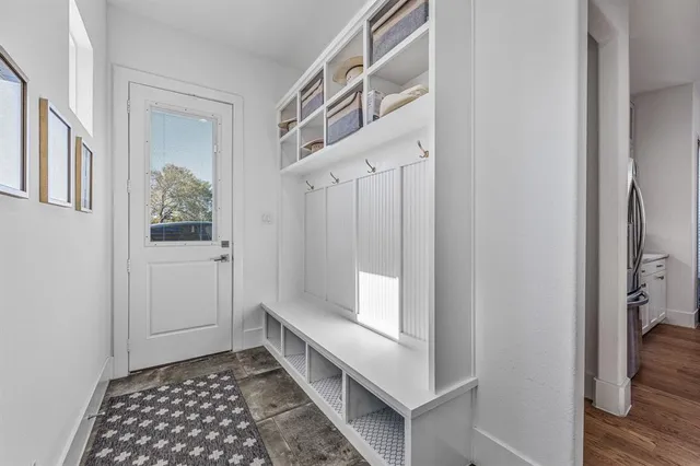 a hallway with windows and flowerpot