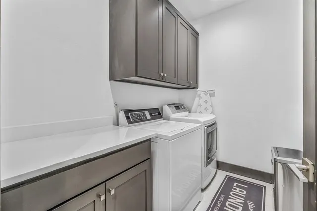 a utility room with sink dryer and washer