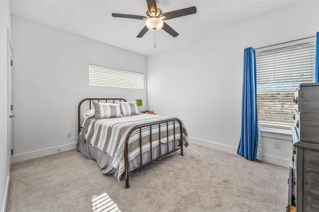 a spacious bedroom with a bed and a chandelier