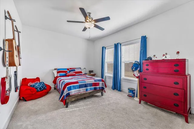 a bedroom with a bed and a ceiling fan