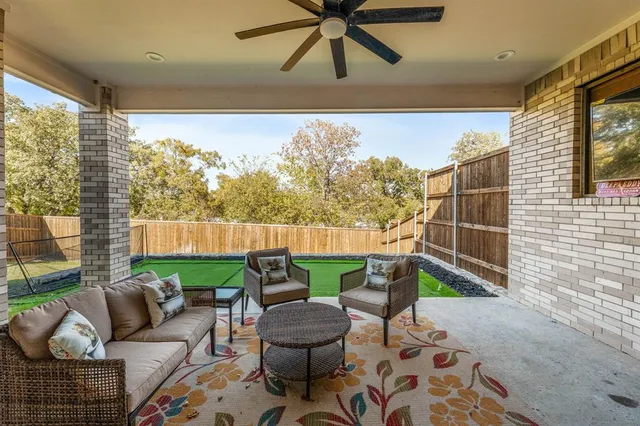 a view of a patio with couches chairs and a potted plant