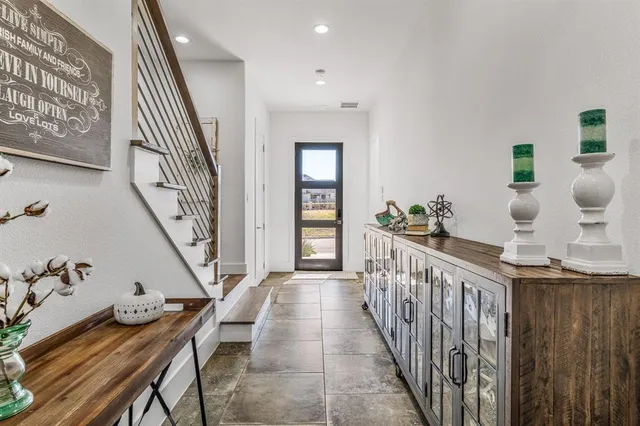 a view of entryway and hall with wooden floor