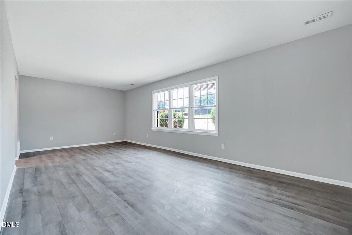 3408 Atlantic Avenue Raleigh, NC 27604 - Photo 23 of 48 an empty room with wooden floor and windows