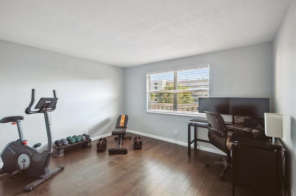 131 Southeast 3rd Avenue, Unit 302 Dania Beach, FL 33004 - Photo 13 of 16 a view of a workspace with furniture and a window