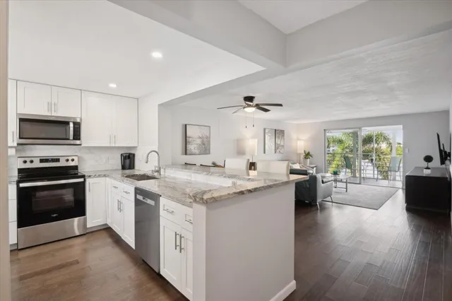 a kitchen with a stove cabinets and wooden floor