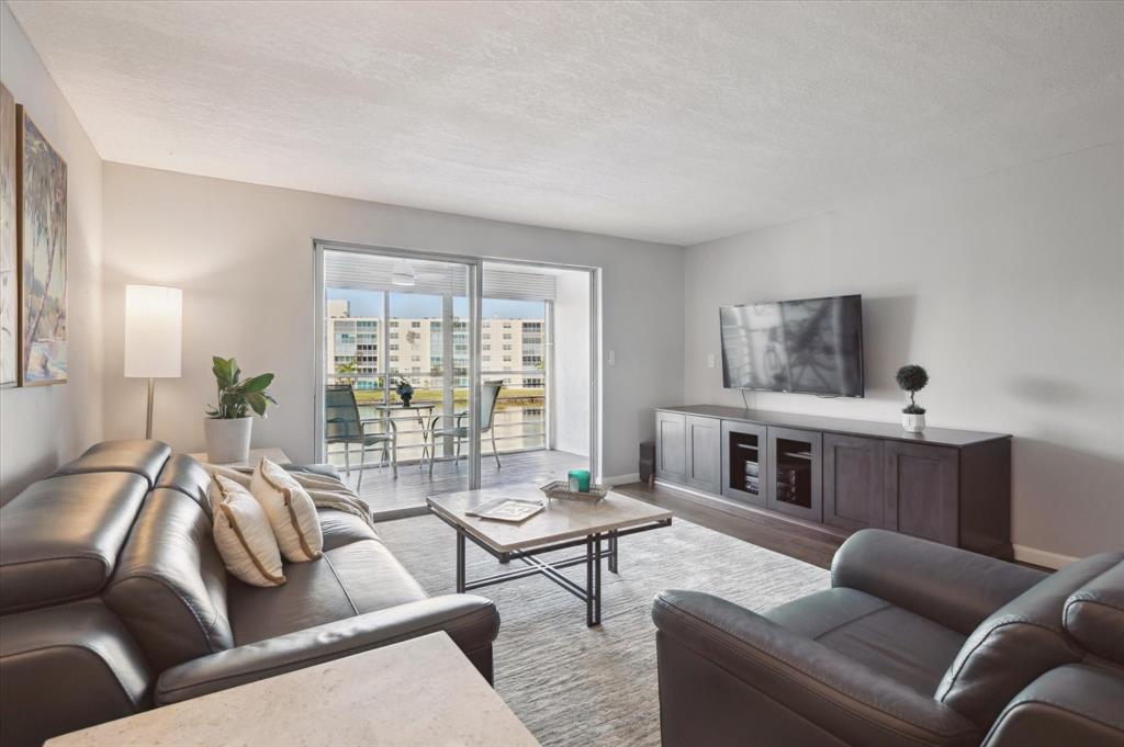 131 Southeast 3rd Avenue, Unit 302 Dania Beach, FL 33004 - Photo 6 of 16 a living room with furniture and a large window