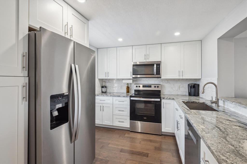 131 Southeast 3rd Avenue, Unit 302 Dania Beach, FL 33004 - Photo 9 of 16 a kitchen with stainless steel appliances granite countertop a refrigerator stove and oven
