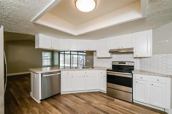 a kitchen with stainless steel appliances granite countertop a stove and a sink
