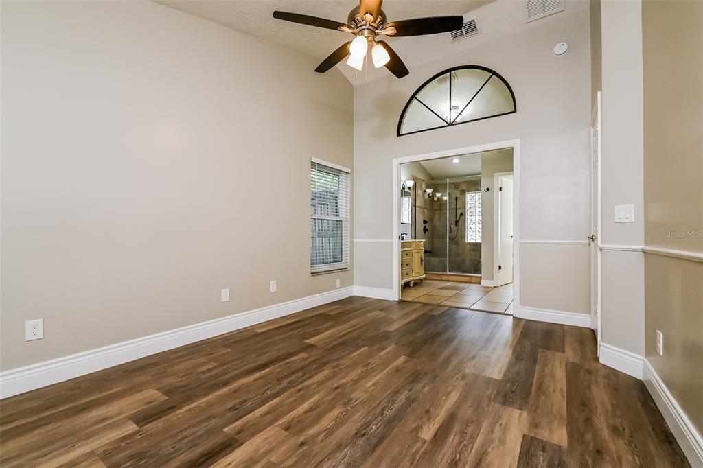 1601 Loghill Place Brandon, FL 33510 - Photo 10 of 15 a view of empty room with wooden floor and fan