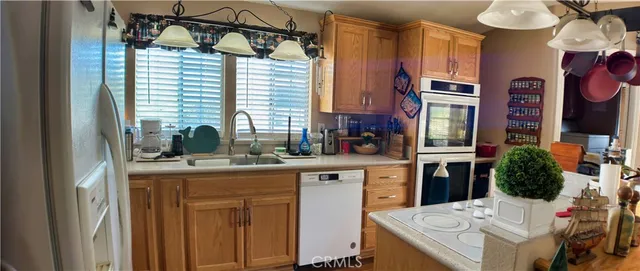 a kitchen that has a cabinets a sink and a stove