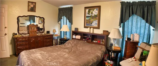 a bed room with a bed and a television