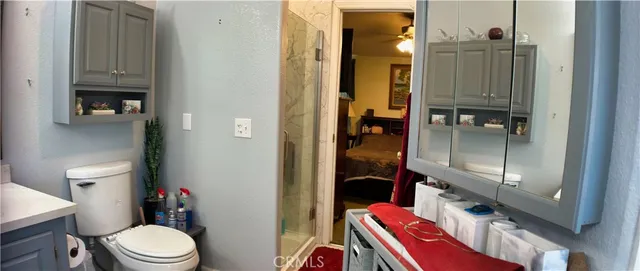 a bathroom with a toilet and a shower