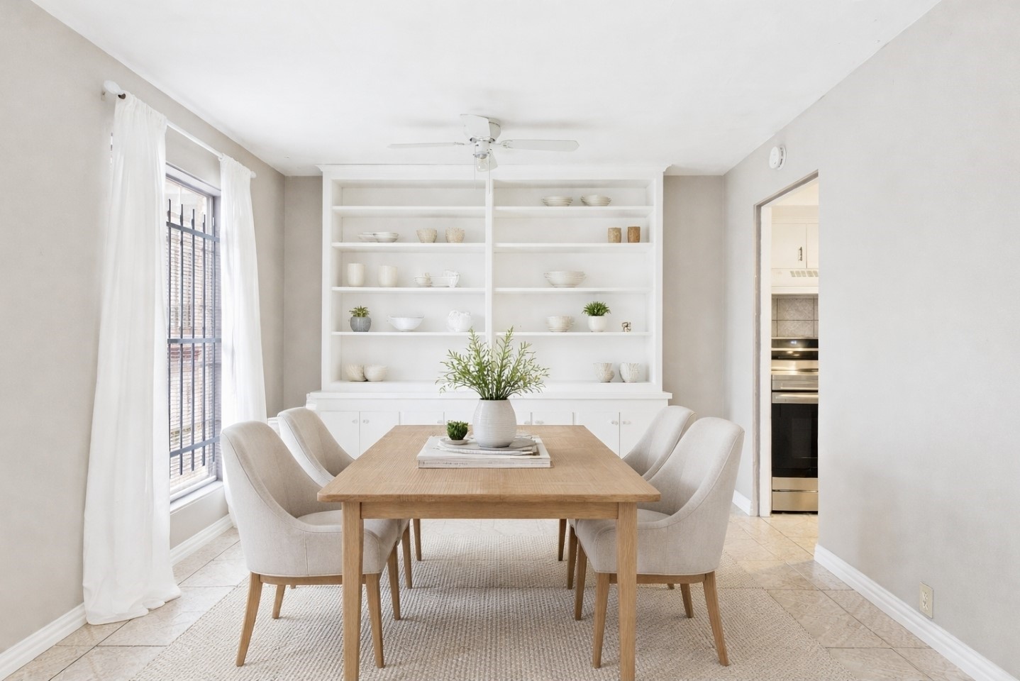 6500 Rampart Street, Unit 28 Houston, TX 77081 - Photo 3 of 19 Light filled dining with built-in shelving. Virtually Staged
