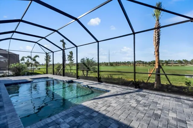 a view of a swimming pool with a yard