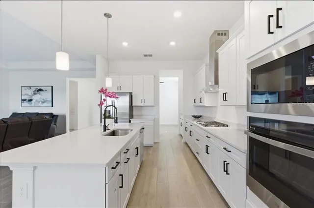 a kitchen with kitchen island a sink stove and cabinets