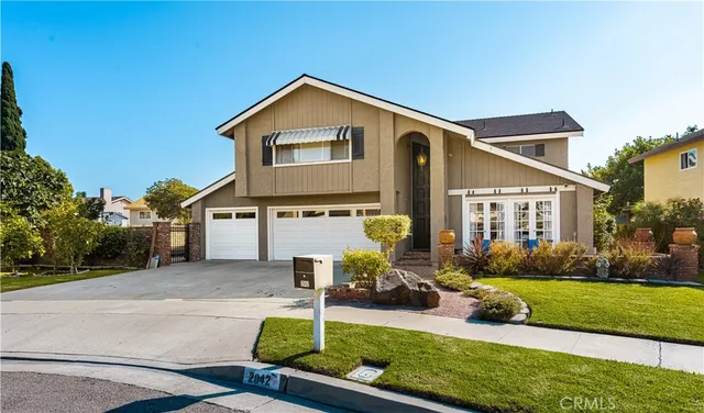 a front view of a house with a yard table and chairs