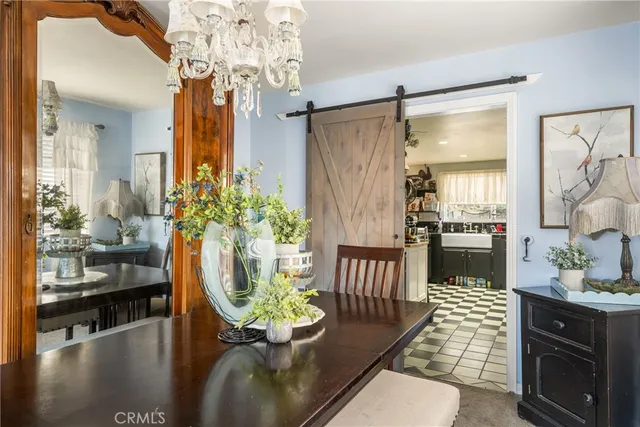 a hallway with dining area and chandelier