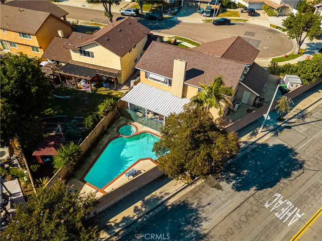 an aerial view of a residential houses with street