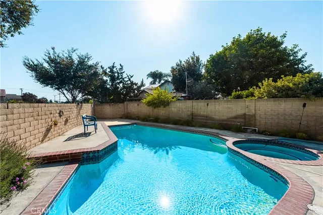 a view of a swimming pool with a lounge chair