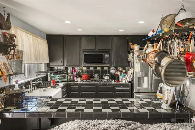 a kitchen with stove and cabinets