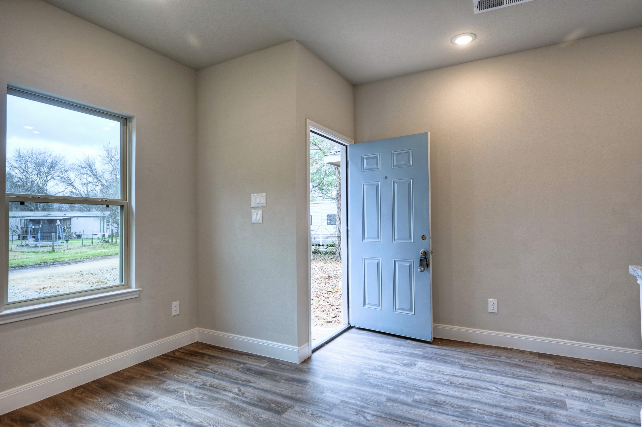 9173 Inwood Willis, TX 77318 - Photo 9 of 31 an empty room with wooden floor and windows
