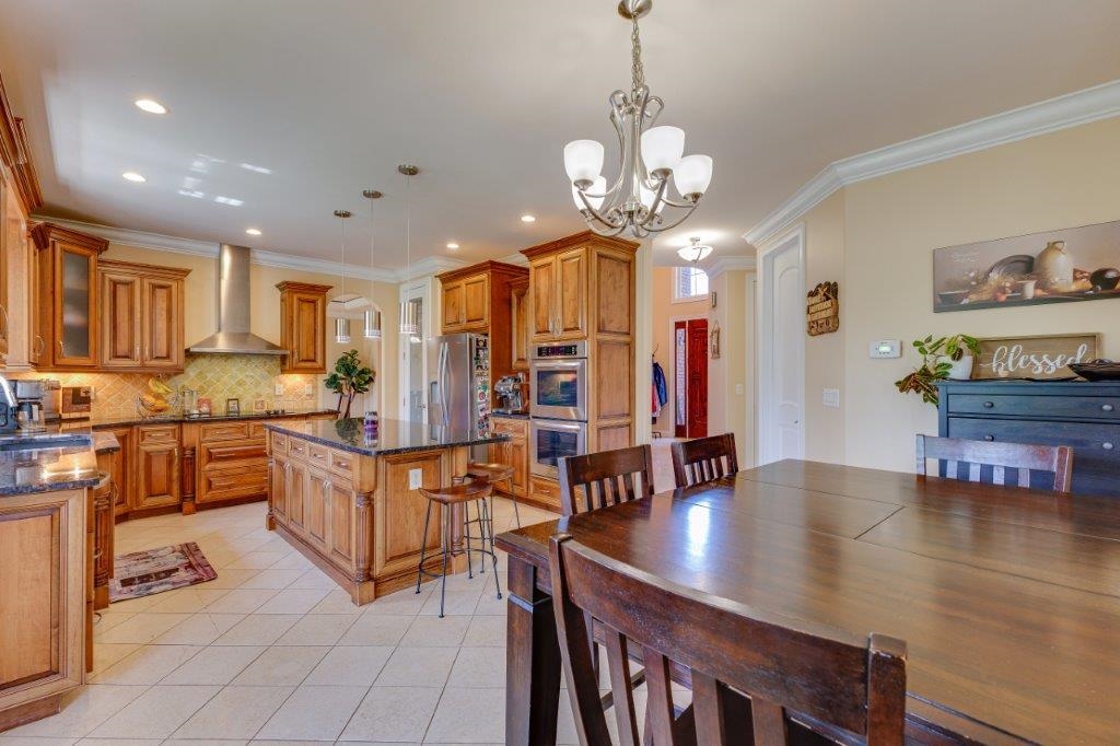 61 Bridgewater Road Bridgewater, VA 22812 - Photo 15 of 75 a view of a dining room with furniture a chandelier and wooden floor