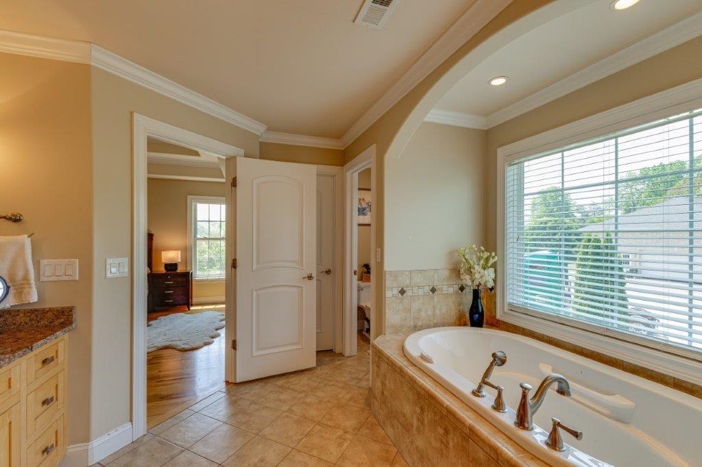 61 Bridgewater Road Bridgewater, VA 22812 - Photo 34 of 75 a bathroom with a tub a sink and a large mirror