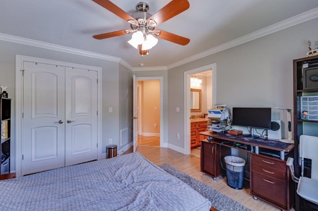 61 Bridgewater Road Bridgewater, VA 22812 - Photo 45 of 75 a bedroom with a bed and a chandelier