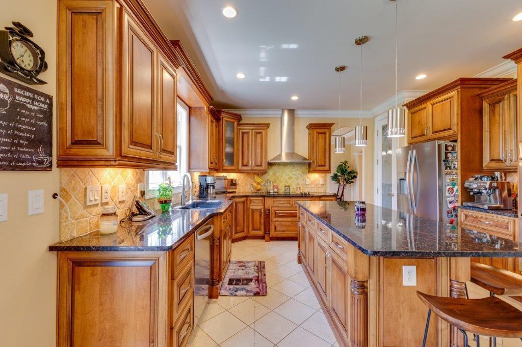 61 Bridgewater Road Bridgewater, VA 22812 - Photo 5 of 75 a kitchen with stainless steel appliances granite countertop a refrigerator a sink dishwasher a stove and white cabinets with wooden floor