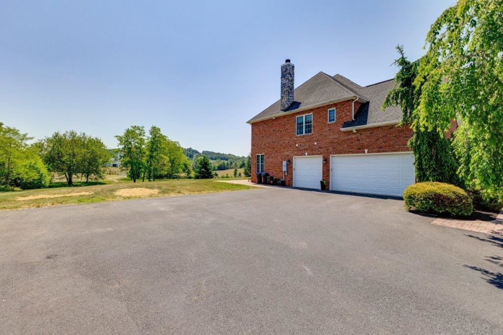 61 Bridgewater Road Bridgewater, VA 22812 - Photo 59 of 75 a front view of a house with a yard and garage