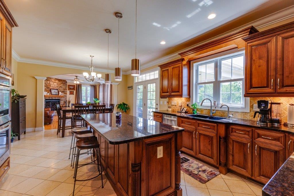 61 Bridgewater Road Bridgewater, VA 22812 - Photo 8 of 75 a kitchen with stainless steel appliances granite countertop a refrigerator a sink dishwasher a dining table and chairs with wooden floor
