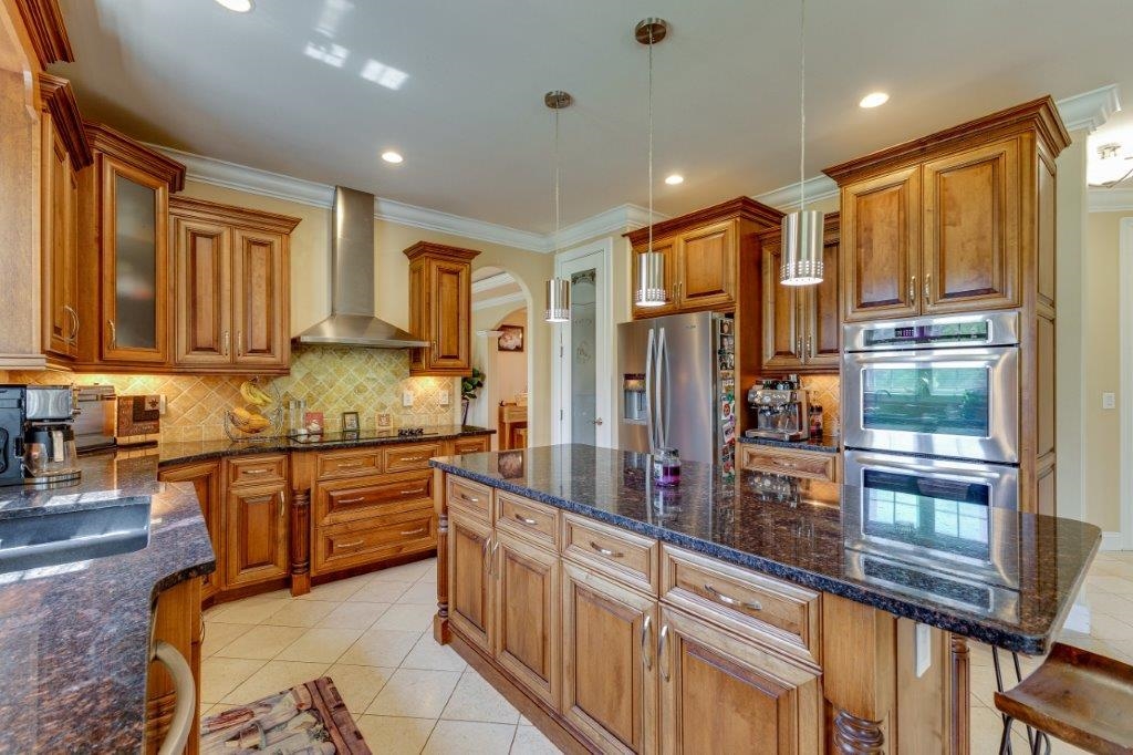61 Bridgewater Road Bridgewater, VA 22812 - Photo 9 of 75 a kitchen with stainless steel appliances granite countertop a refrigerator a stove and a sink with wooden cabinets