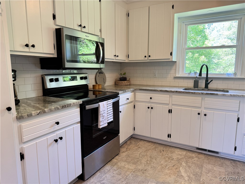 2729 Cumberland Road Farmville, VA 23901 - Photo 21 of 45 a kitchen with granite countertop white cabinets and a stove