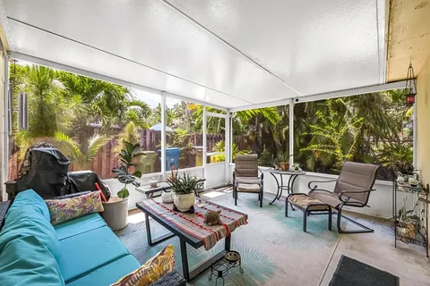a living room with furniture and floor to ceiling windows