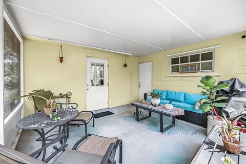 a living room with furniture and flowers