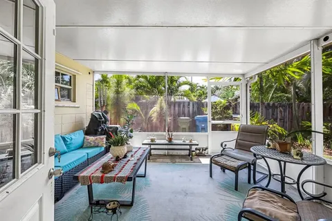 a living room with furniture and a floor to ceiling window