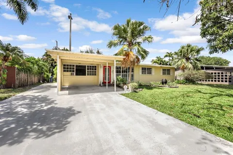 a front view of a house with a garden and yard