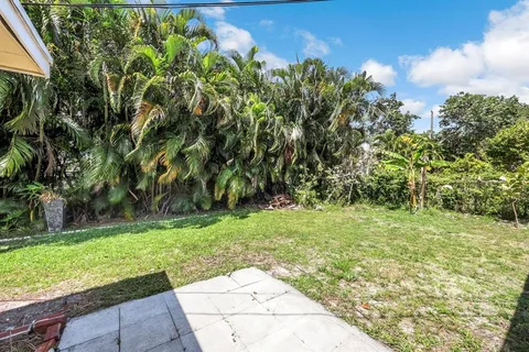 a backyard of a house with lots of green space and garden