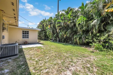 a view of backyard with barbeque grill and plants