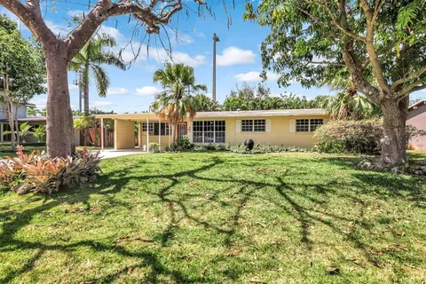 a view of backyard of house with green space
