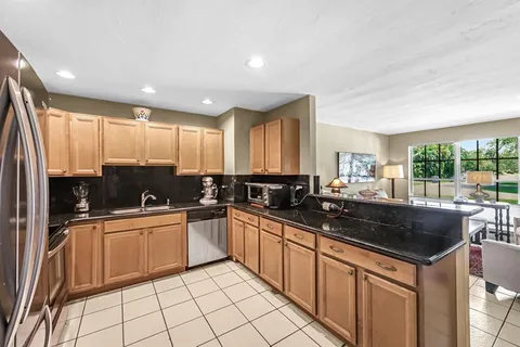 a kitchen with stainless steel appliances a sink stove and cabinets