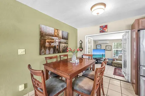 a view of a dining room with furniture large window and outside view
