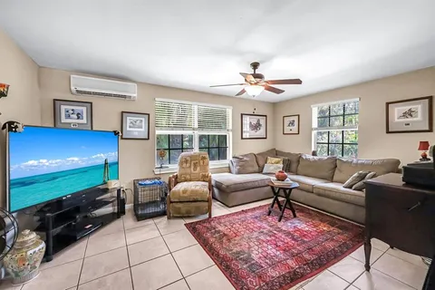 a living room with furniture rug and window