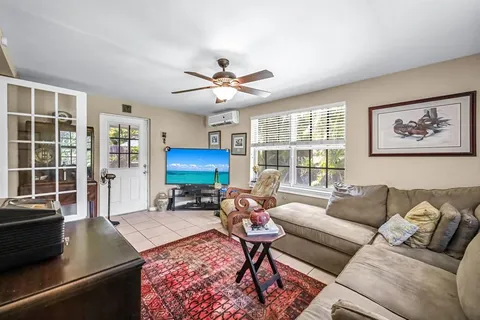 a living room with furniture a table and a large window