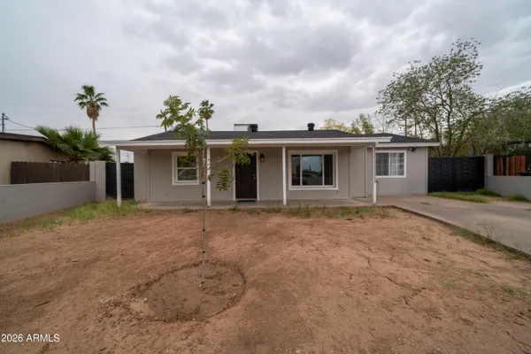 a view of a house with a backyard and garden