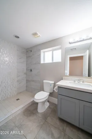 a bathroom with a sink toilet and shower