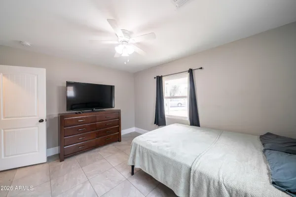 a bedroom with a bed and a flat screen tv