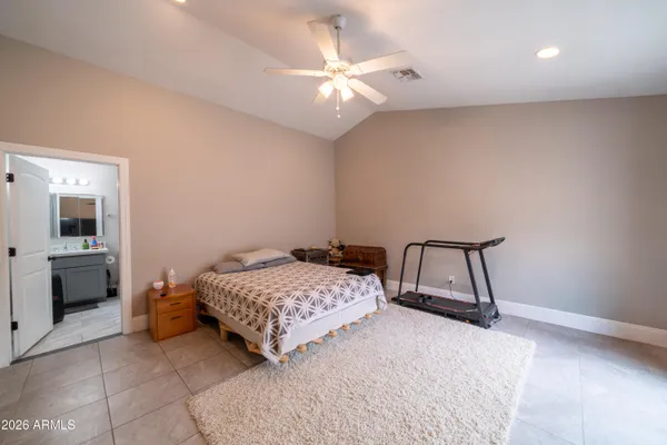 a bedroom with a bed and a ceiling fan
