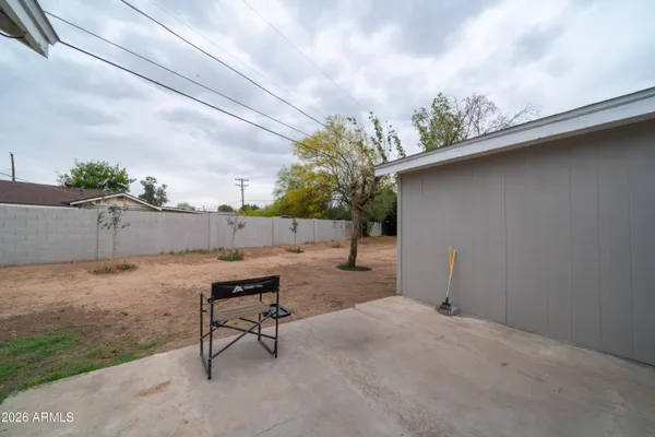 a backyard of a house with table and chairs