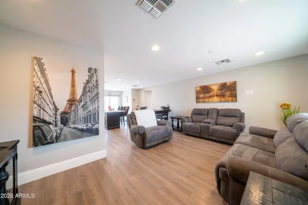 a living room with furniture and wooden floor